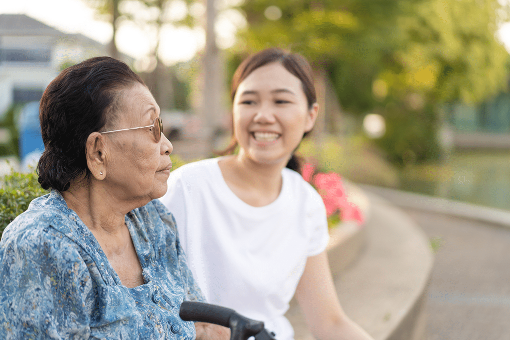 Grandma sitting beside her granddaughter in a park.