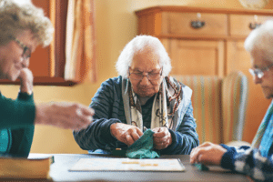 senior women playing board game together