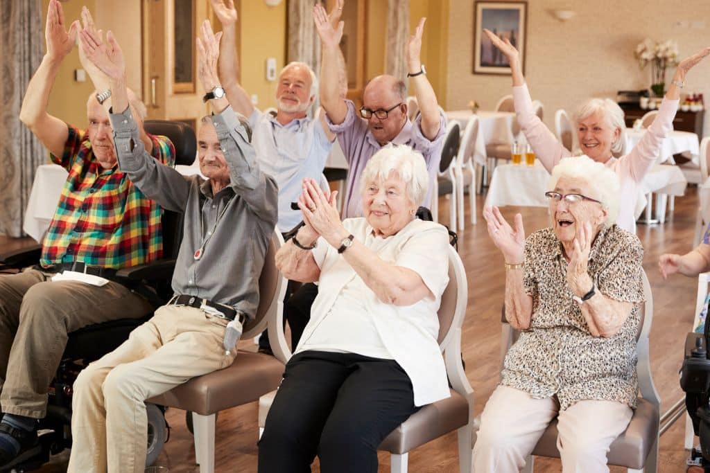 Group Of Seniors Enjoying Fitness Class In senior living facility