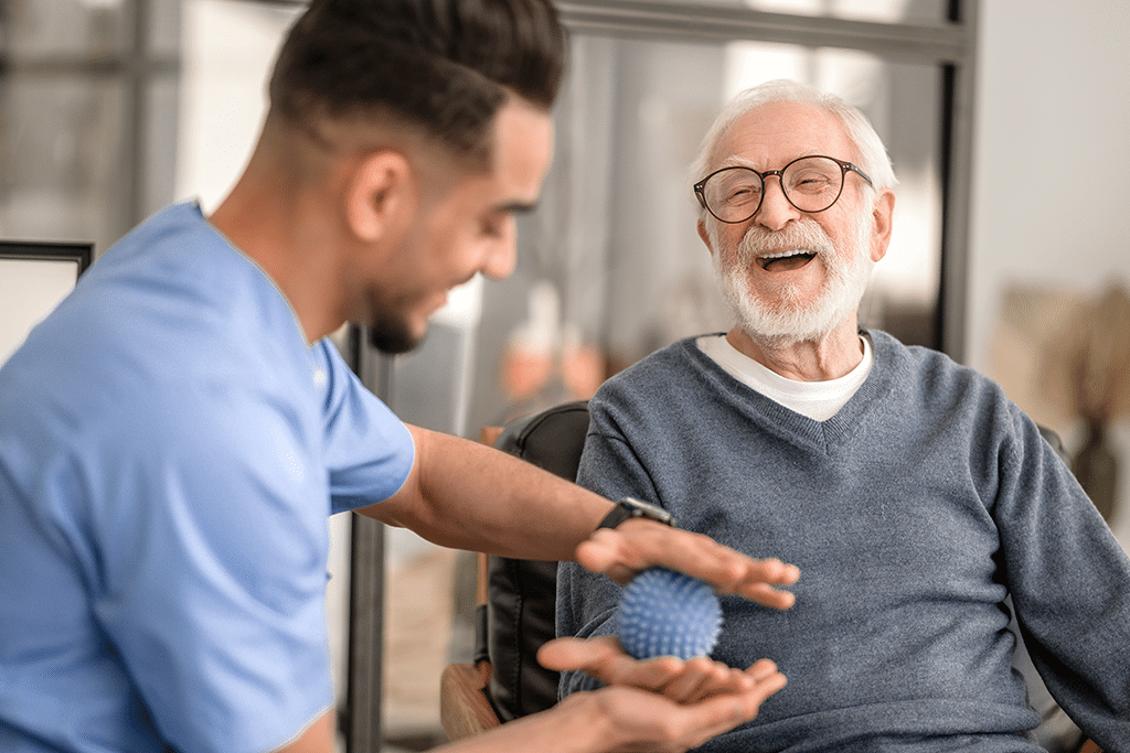 Patient having his hand massaged with a spiky massage ball